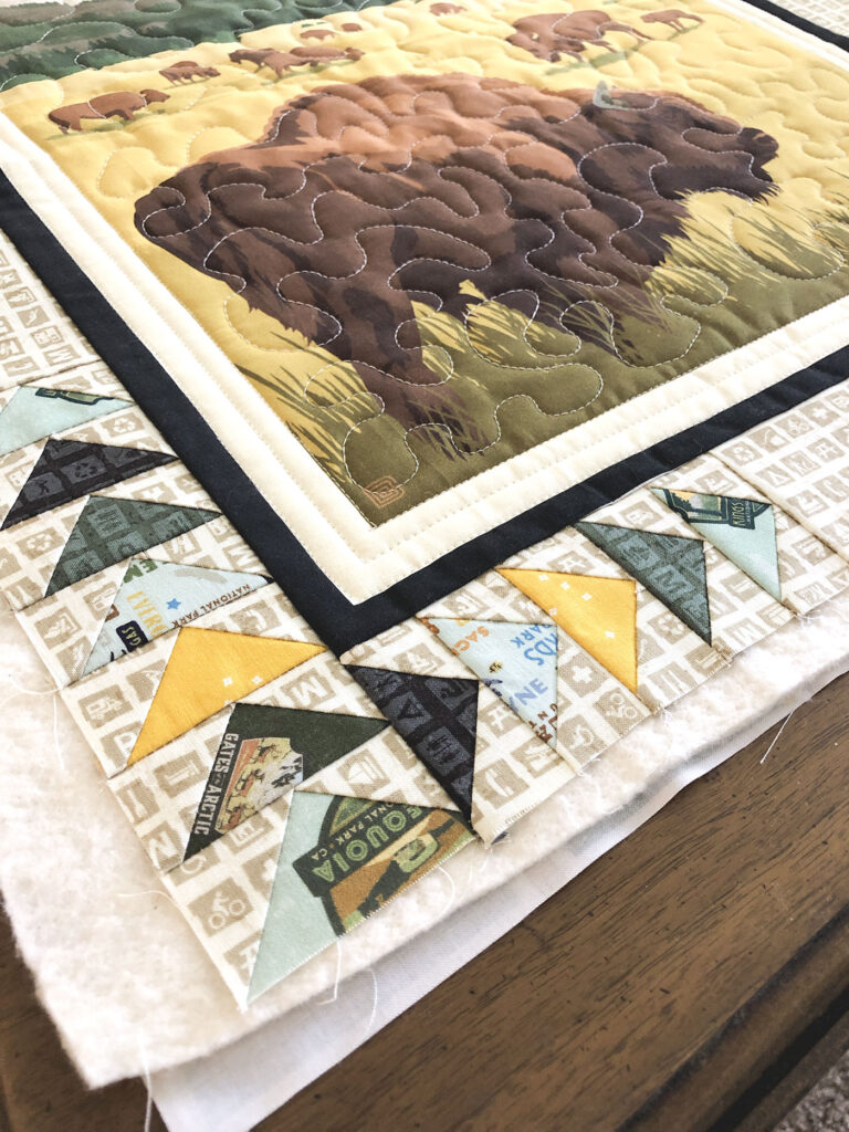 Flying Geese blocks in the Mini quilte border.