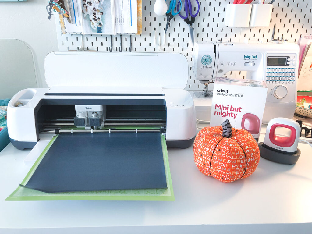 Cricut Maker, Easy Press Mini and fabric pumpkin are supplies needed to make Fabric Jack O lantern