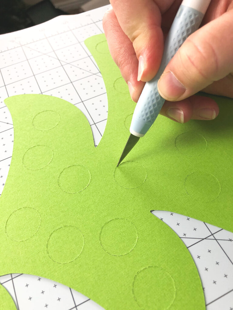 Personalized Christmas Countdown featured by top US craft blog Ameroonie Designs: image of cutting blade creating slit in perforated circle