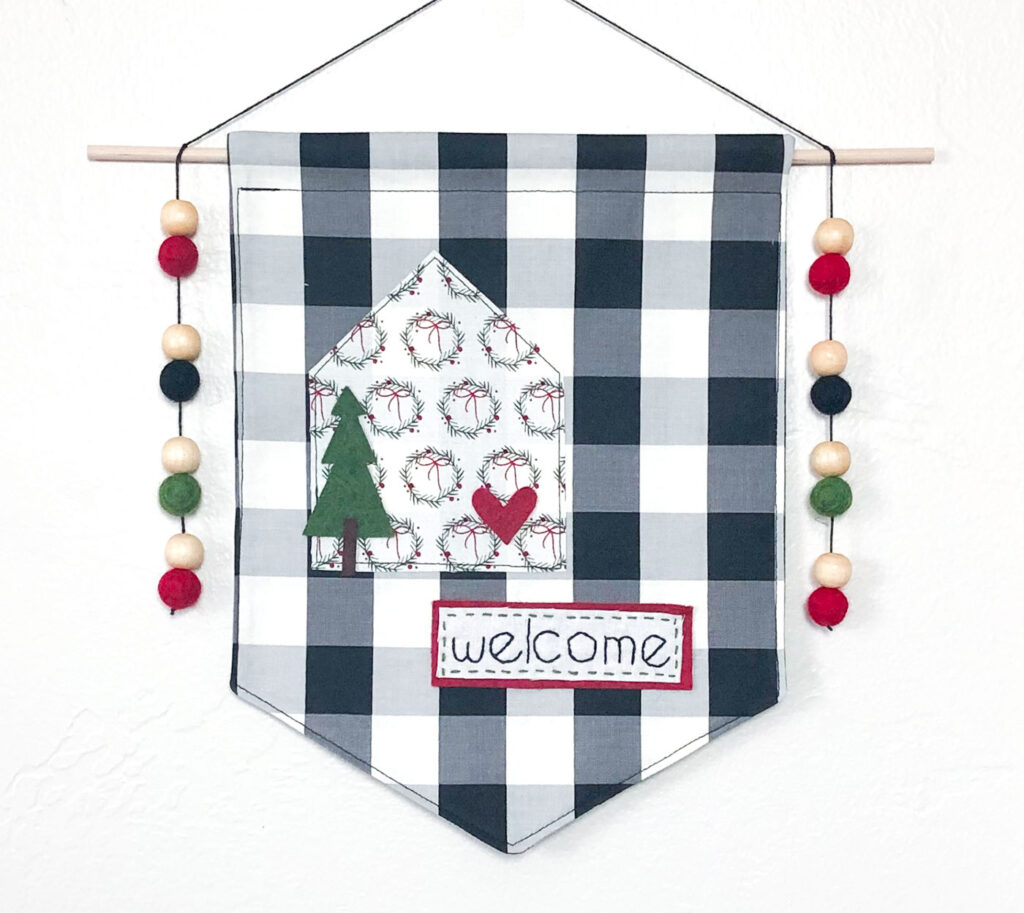 Welcome Wall Banner DIY featured by Top US sewing blog Ameroonie Designs: image shows a Christmas version of the Welcome wall banner with tree and bead embellishments.