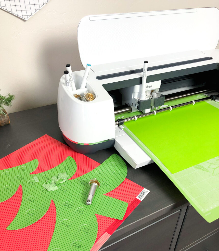 Personalized Christmas Countdown featured by top US craft blog Ameroonie Designs: image of Cricut Maker cutting out pattern pieces.