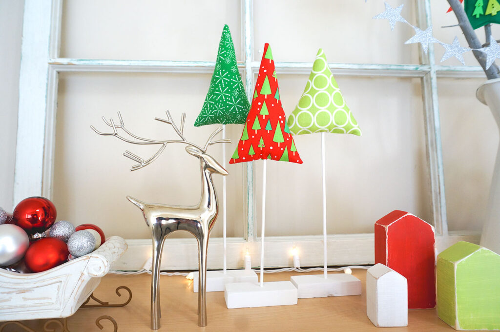 Fabric Tree tutorial by top US sewing blog Ameroonie Designs: Image of fabric trees in holiday setting.