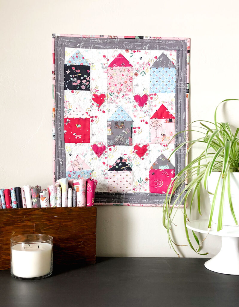 Community Love mini quilt by Top US Sewing Blog Ameroonie Designs. Image of: House mini quilt with hearts.