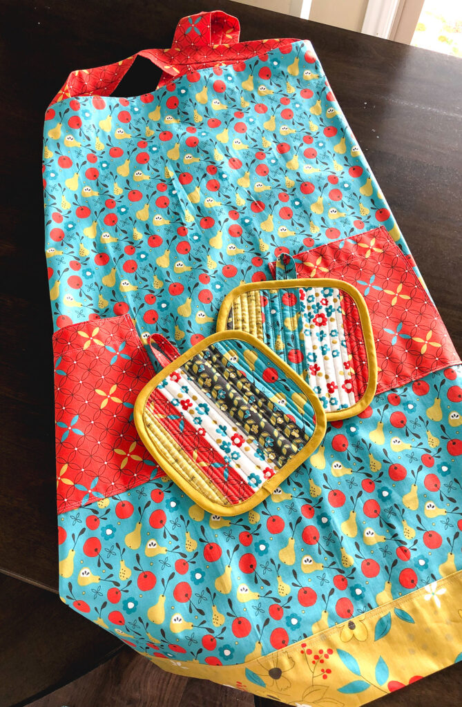 On The Bright Side fabric blog tour by top US sewing blog Ameroonie Designs. Image of: Apron and hot pads made with On the Bright Side fabric.