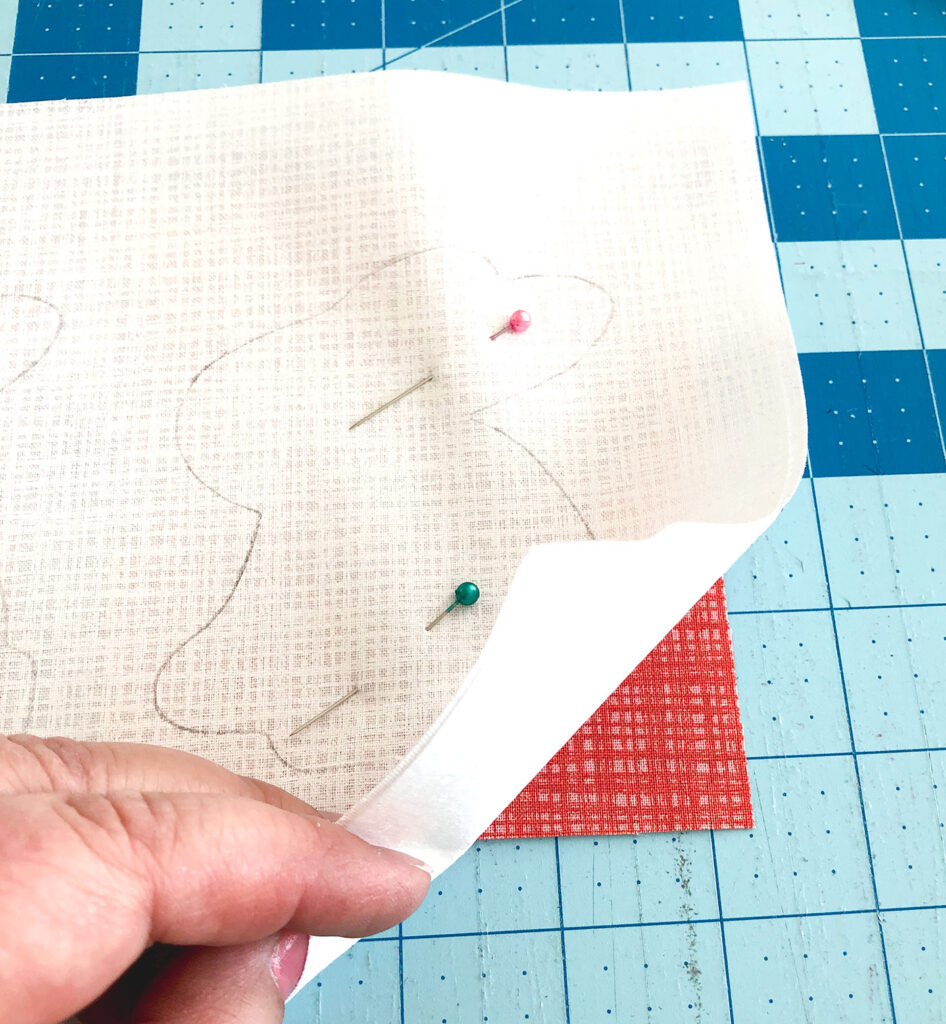 Bunny Hop Pillow tutorial by Top US sewing blog Ameroonie Designs: image of placing fabric behind bunny to create reverse applique.