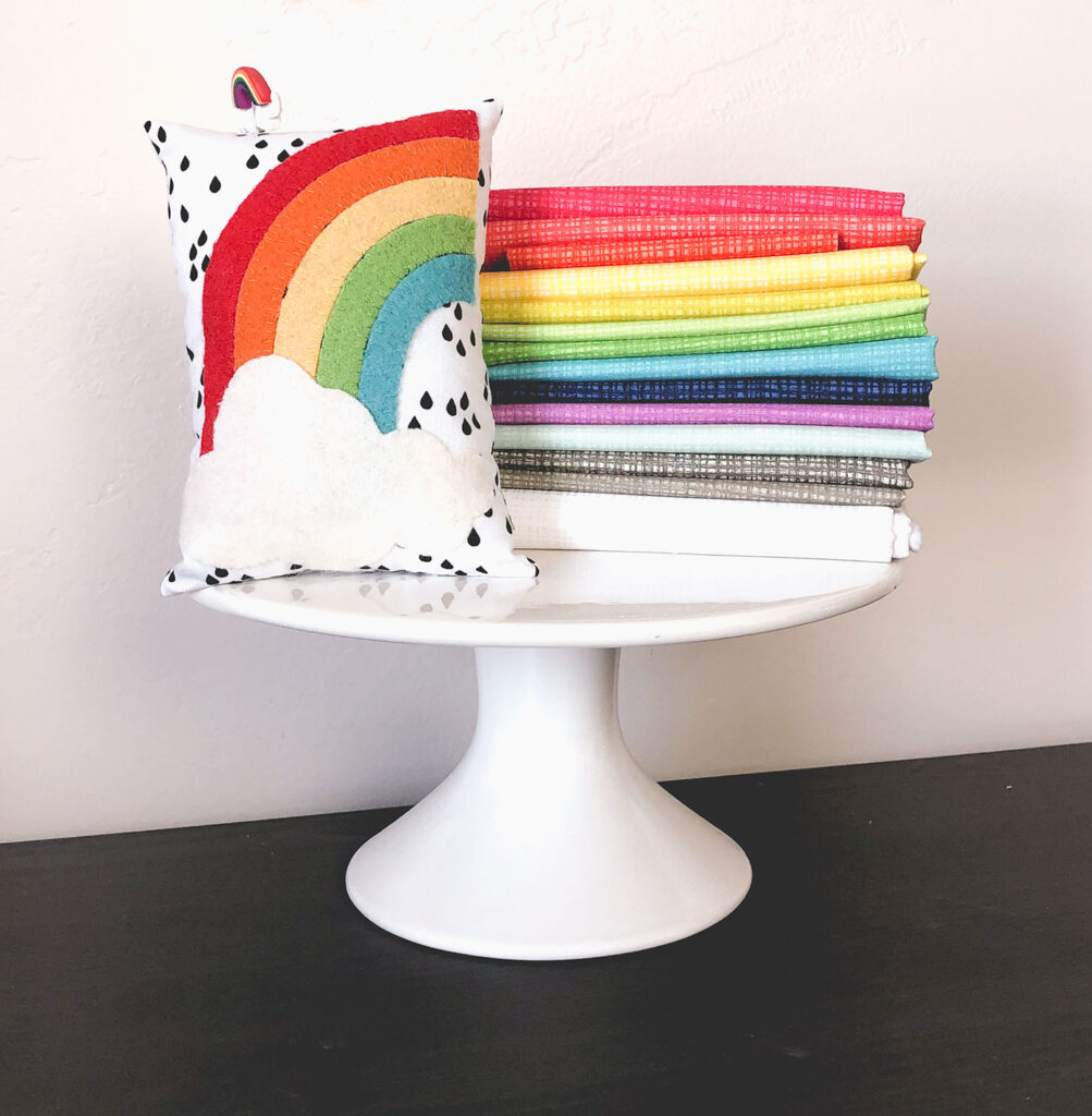 Texture Fabric Blog Tour by Top US sewing blog Ameroonie Designs: image of rainbow colored fabric and wool applique pincushion