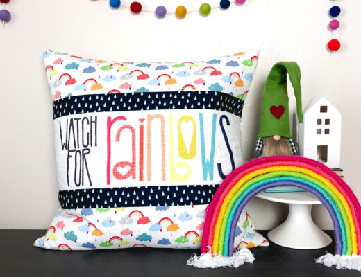Watch for Rainbows Pillow tutorial by Top US sewing blog Ameroonie Designs: Image of quilted pillow with rainbow and garland