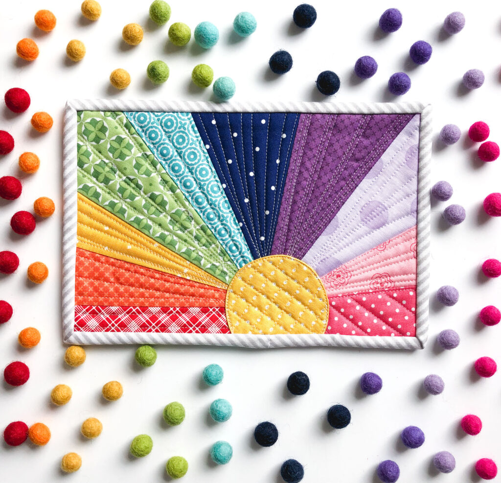 Rainbow Sunset Mug Rug tutorial by Top US sewing blog Ameroonie Designs. Image of: finished mug rug with true rainbow colors.