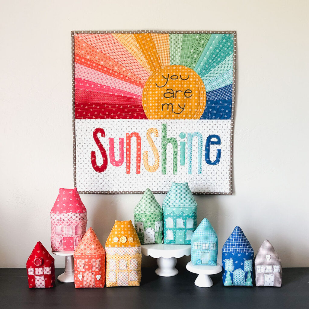 Rainbow Village with Prim fabric by Top US sewing blog Ameroonie Designs: image of Rainbow Village and Rainbow Sunshine mini quilt.