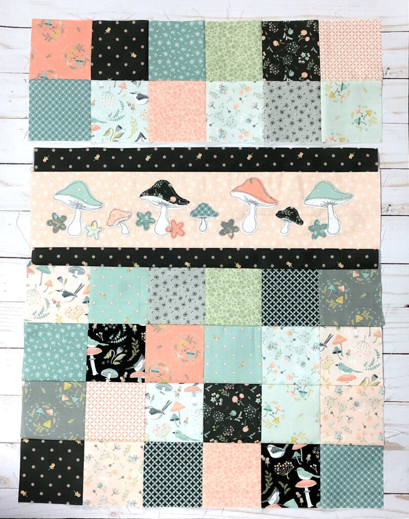 Patchwork doll quilt by top US sewing blog Ameroonie Designs. Image of sewing patchwork blocks to applique strip.