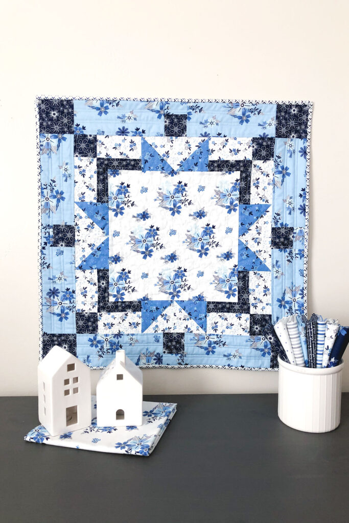 Easy table topper quilt by Top US sewing blog Ameroonie Designs. Image of: mini quilt with Blue Stitch fabric.