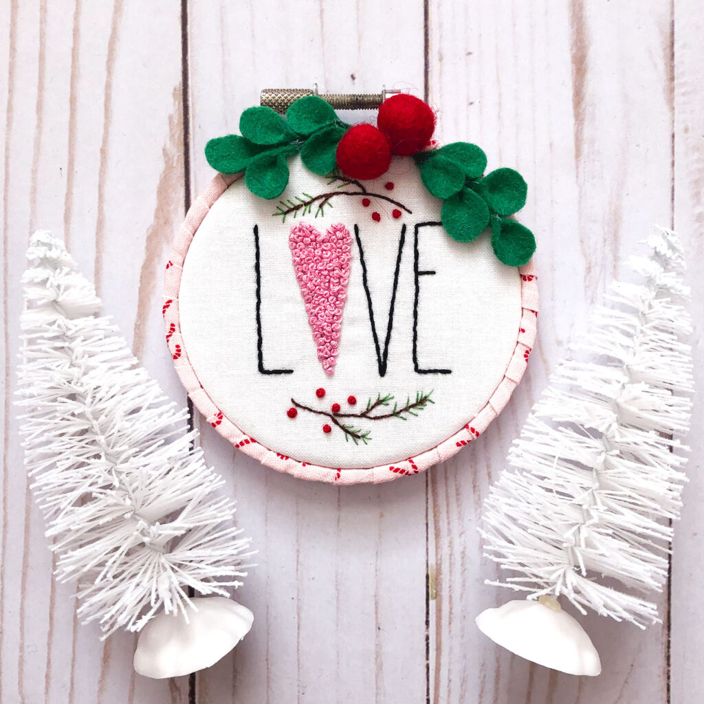 Customized Embroidered Ornaments by Top US craft blog Ameroonie Designs. Image of LOVE ornament with white trees.