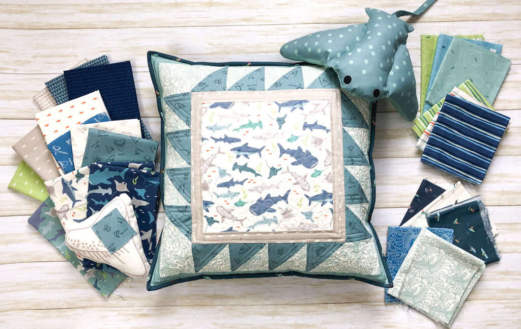 Shark teeth pillow by top US sewing blog Ameroonie Designs. Image quilted pillow and Riptide quilting fabric.