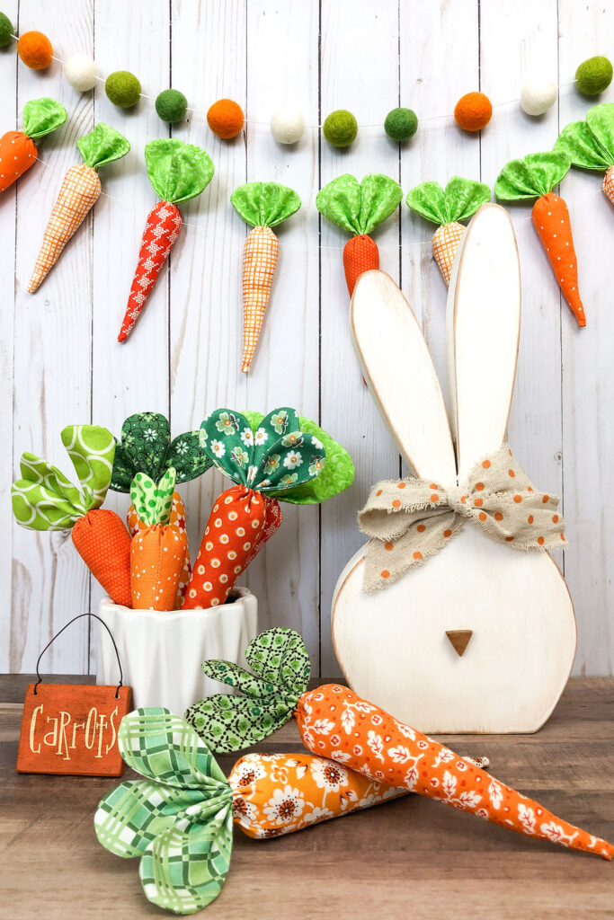 How to sew fabric carrots with top US sewing blog Ameroonie Designs. Image of wood bunny with medium and mini fabric carrots.