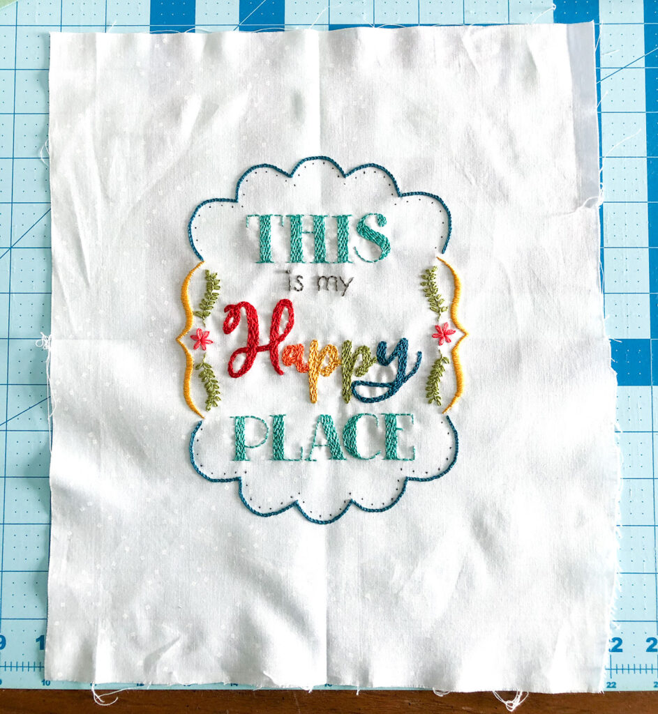 Turn your embroidery into a stunning mini quilt by Top US sewing blog Ameroonie Designs. Image of embroidery with center marked with finger presses before cutting to size.