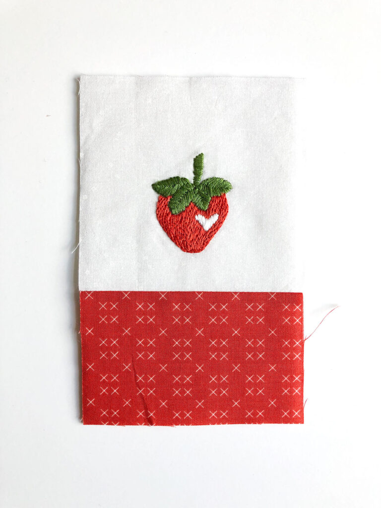 How to sew an easy embroidered strawberry mini pillow with top US sewing blog Ameroonie Designs. Image of assembly of mini pillow front.