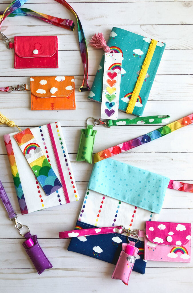 7 simple sewing projects to make this weekend from top US sewing blog Ameroonie Designs. Image of mini wallets on lanyards, fabric covered notebooks, bookmarks and chapstick holders on wriststraps along with a sling tote all in Dream fabrics.