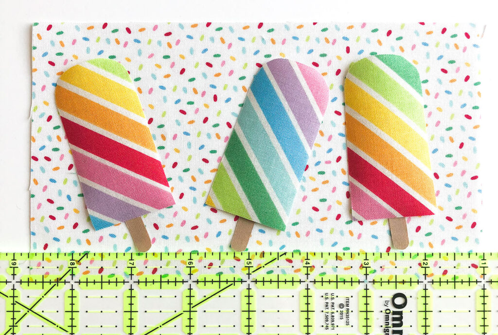 Free popsicle mug rug sewing tutorial with top US sewing blog Ameroonie Designs. Image of positioning applique on background fabric.