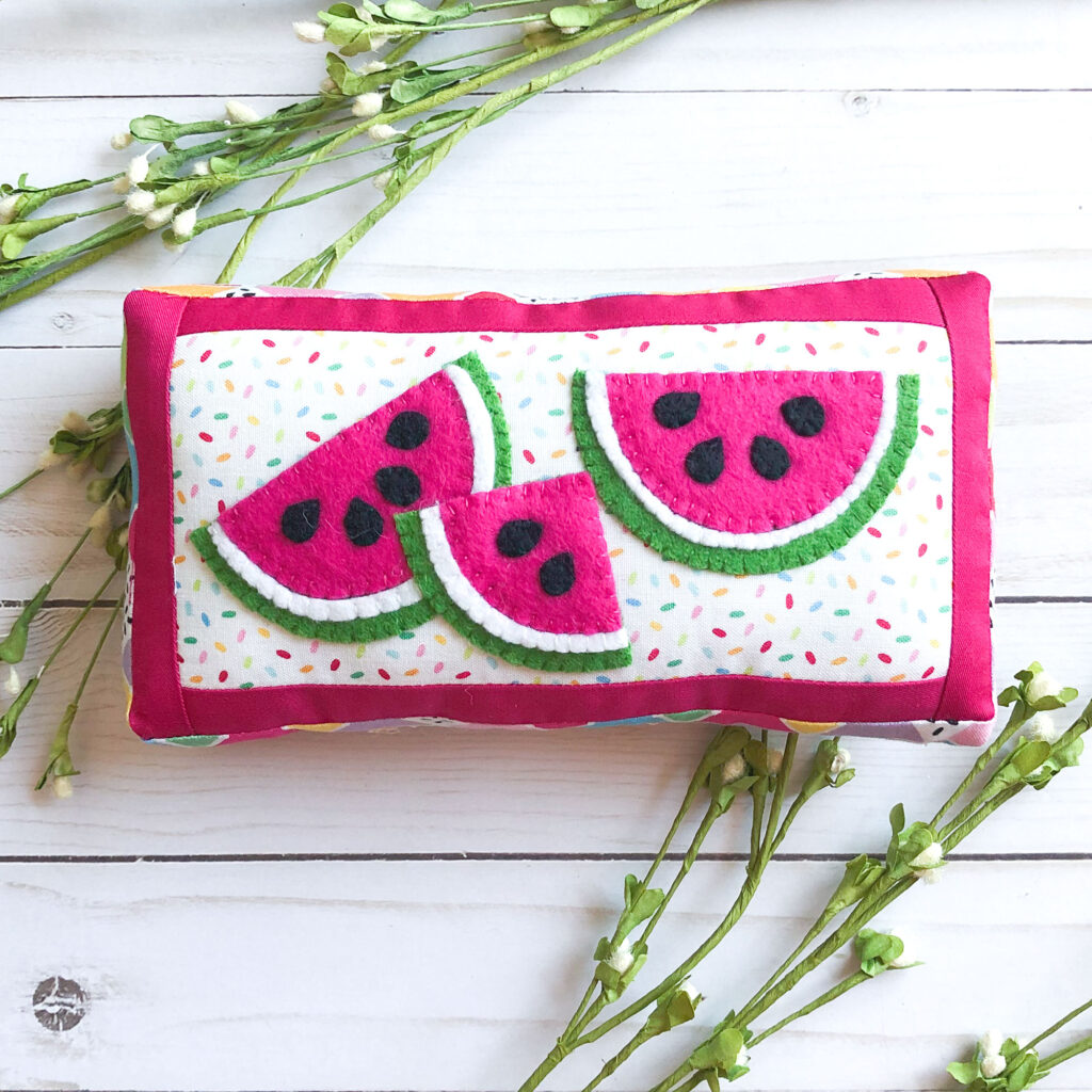 How to sew a fabric cover for a mini notebook with top US sewing blog Ameroonie Designs. Image of watermelon applique on mini pillow.