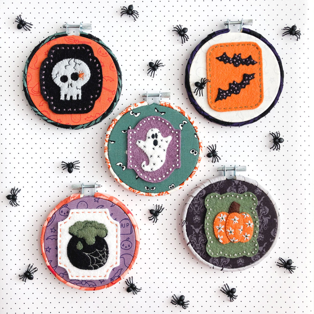 New Halloween Sewing patterns by top US sewing blog Ameroonie Designs. Image of felt applique Halloween ornaments with embroidery embellishments.