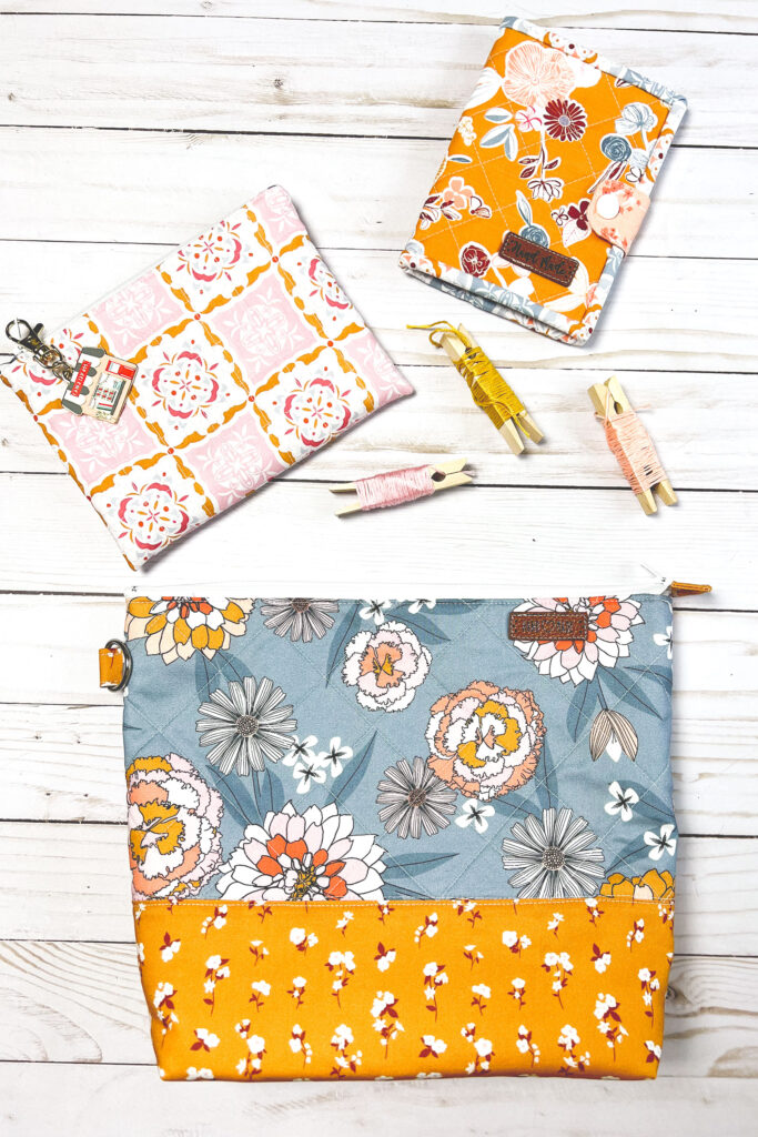 Practical projects to organize your hand sewing by Top US sewing blog Ameroonie Designs. Image of embroidery floss scattered around zipper pouches and a needle book.