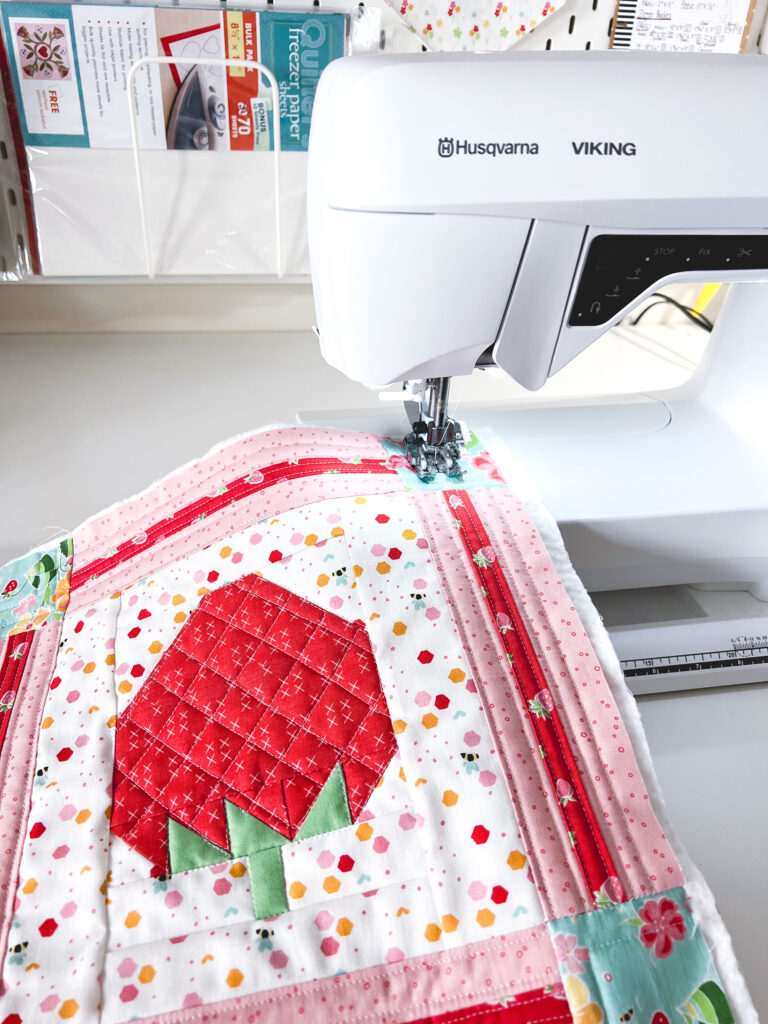 https://amerooniedesigns.com/wp-content/uploads/2022/04/strawberry-mini-quilt-quilting-on-machine-768x1024.jpg