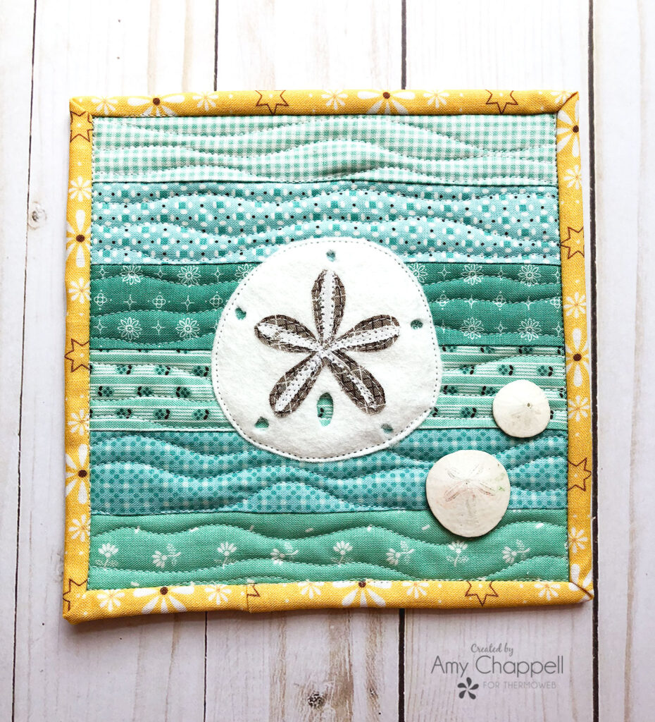 Quick and Satisfying Summer sewing by Top US sewing blog Ameroonie Designs. Image of Sand Dollar applique on mini quilt.