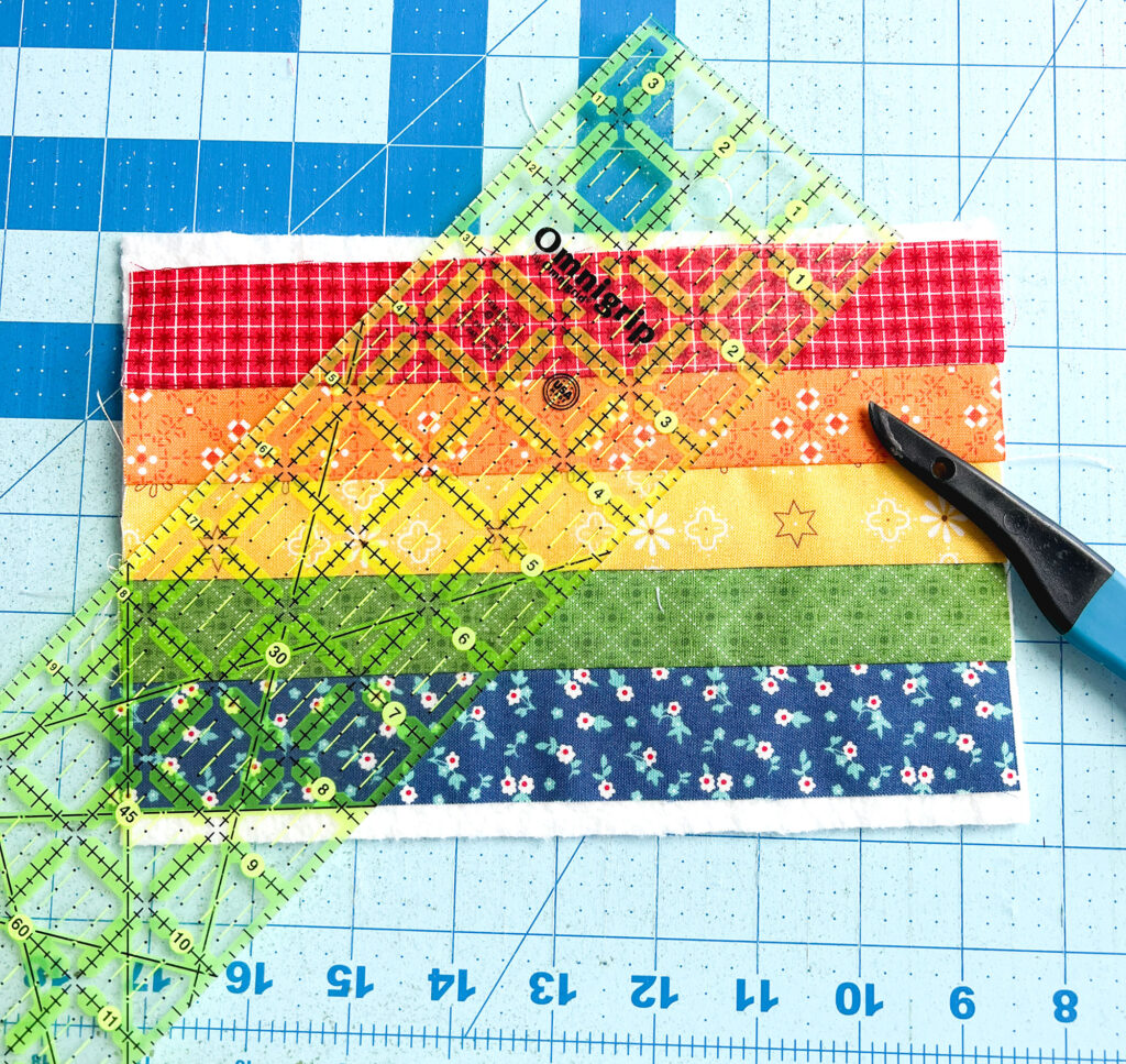 Free Needle Book Pattern from Top US sewing blog Ameroonie Designs. Image of adding marking lines to guide quilting on needle book cover.
