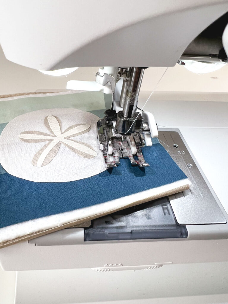 Free Sand Dollar Coaster sewing pattern by top US sewing blog Ameroonie Designs. Image of sewing machine stitching around applique.