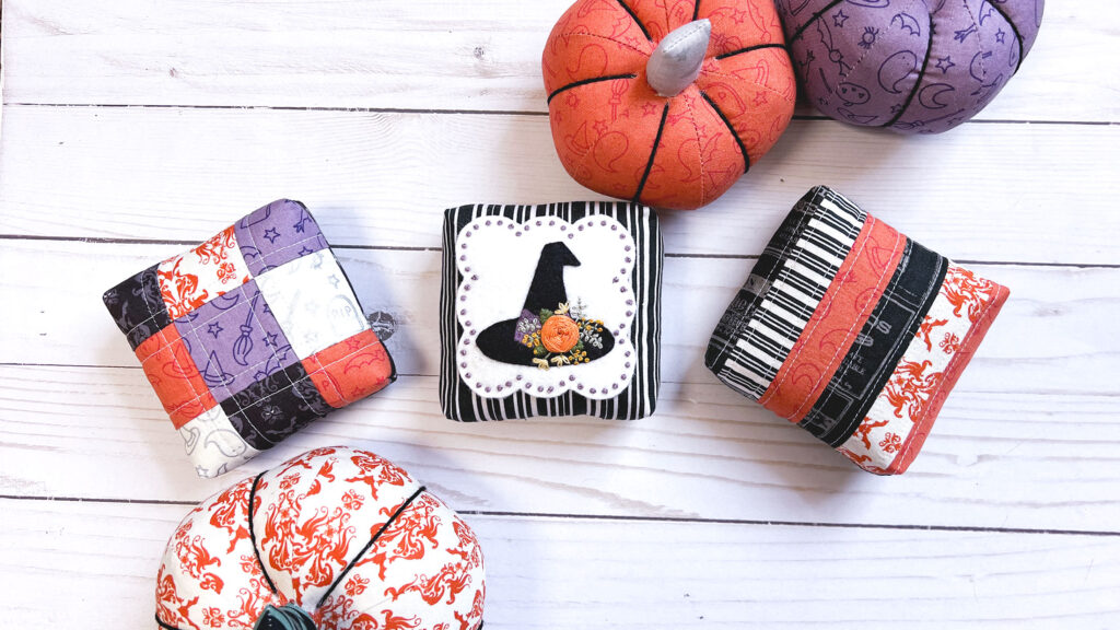 How to sew a mini pillow by top US sewing blog Ameroonie Designs. Image of mini pillows surrounded by fabric pumpkins.