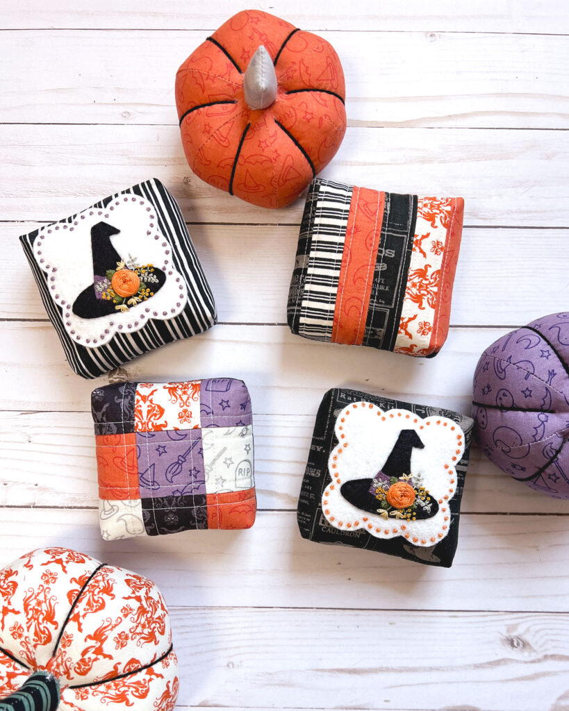 How to sew a mini pillow by top US sewing blog Ameroonie Designs. Image of quilted patchwork and felt appliqued mini pillows and fabric pumpkins.