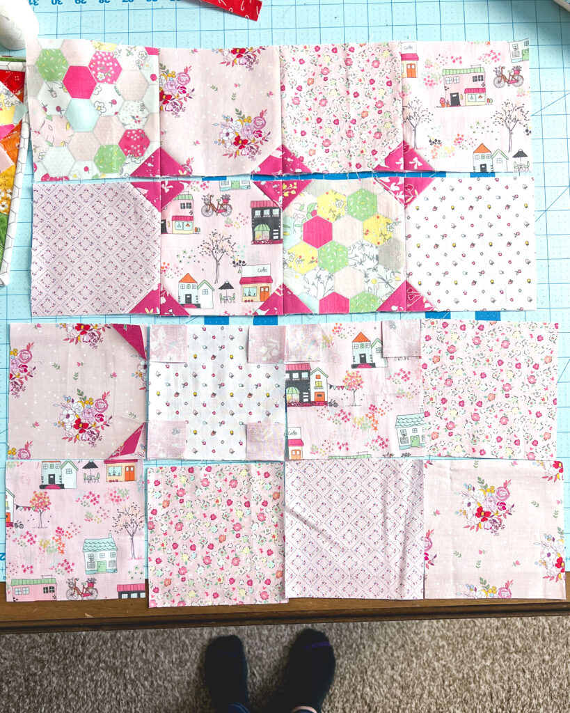 Sew a pretty patchwork pillow with pizzazz with top US sewing blog Ameroonie Designs. Image of laying out fabric squares and sewing.