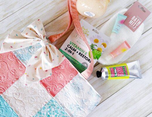 A handmade quilted tote bag with spa gift items.